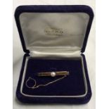 Pearl set tie clip marked 10K total weight 3.7gms.