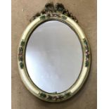 Oval shaped wall mirror in decorative floral painted frame with bow to top. 35cms w x 50cms h.