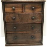 A 19thC mahogany miniature chest of drawers, 2 short over 3 long with turned wooden knobs. 33 h x