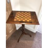 19th century tip top walnut table with chess board top. 75cms h.