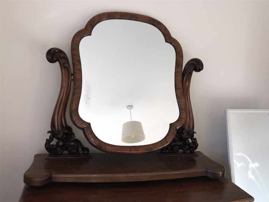 A 19th century mahogany toilet mirror. 89cmsw x 28cms d x 82cms h.