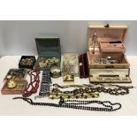 A large quantity of vintage costume jewellery to include glass beads, brooches, earrings etc.