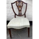 Six mahogany shield back dining chairs with shell inlay.