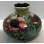 A Moorcroft anemone pattern vase impressed marks and makers to the Queen. 8.5cms h. Good condition.