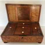 A 19thC burr wood box with fitted interior on bun feet with secret drawers to base. 13 h x 35 w x