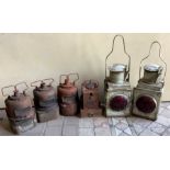 Six vintage railway lamps in unrestored condition, four with surface rust.
