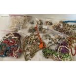 A large quantity of vintage costume jewellery to include necklaces, bracelets and earrings.