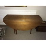 A mid century drop leaf, gate leg dining table. 122cms d.