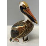 A Royal Crown Derby paperweight in the form of a brown pelican with silver stopper. 12.5cms h.