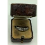 An unmarked ring with two bands of clear stones set in an unmarked yellow metal, band size M/N,