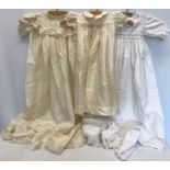An early 20thC silk laced edged christening gown, silk smocked dress and a cotton baby gown.