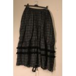 A Maggy Rouff black silk and fringed long skirt, some damage to hem, otherwise good condition.