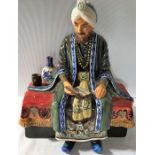 An English Studio Potter figurine of Omar Khayyam by Reginald Johnson, 20cms h in good condition.