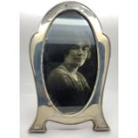 A silver photograph frame, Birmingham 1922, slight dint to top with oak back and stand. 19.5cms h.