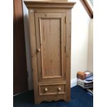 Pine cupboard with single door over one drawer, 134h, 52w, 36d cms