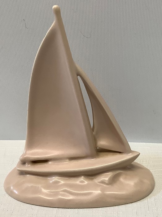 A Poole pottery pastel pink sailing yacht, 15.5cms h after a design by John Adams, made to wall