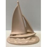A Poole pottery pastel pink sailing yacht, 15.5cms h after a design by John Adams, made to wall