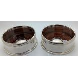 Pair of modern bottle wine coasters, marked .925, 10.5cms d.