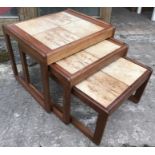 Teak tiled top nest of three tables.