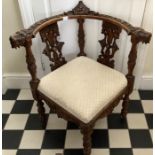 Good quality ornately carved corner chair with lions heads to armrests.