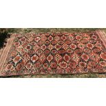 Antique Persian wool rug with flat weave ends. 112cms w x 234cms l.