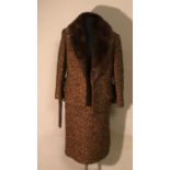 A 1960's skirt suit with fur collar, suede belt in good condition, label Giori Haute mode Zurich.