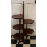 An Edwardian mahogany double sided cake stand. 86cms h.