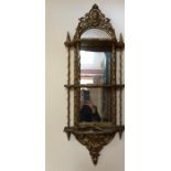 Two 19thC wall mounted mirror backed gilt shelves with decorative plaster mounts.