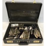 A complete SBS Bestecke canteen of cutlery with 24k gold edging in a combination lock travel case.