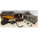A Recall slide projector, an Olympus Trip 35 camera and a NKKI Westeh S-2 No. 46667 camera.