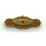 A 19thC 15ct gold brooch set with two diamonds and a pink gem stone, maker N Bs, 5cms l. 5.8gms.