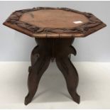 A Chinese carved hardwood table with folding stand, 35cms h, top 36cms d.