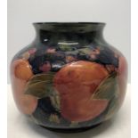 A Moorcroft Pomegranate pattern squat ovoid vase, impressed marks and signed in green to the base.