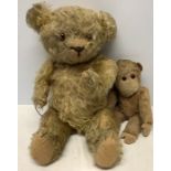 A vintage straw filled teddy, one arm and leg /f with a Merrythought monkey, arm a/f.