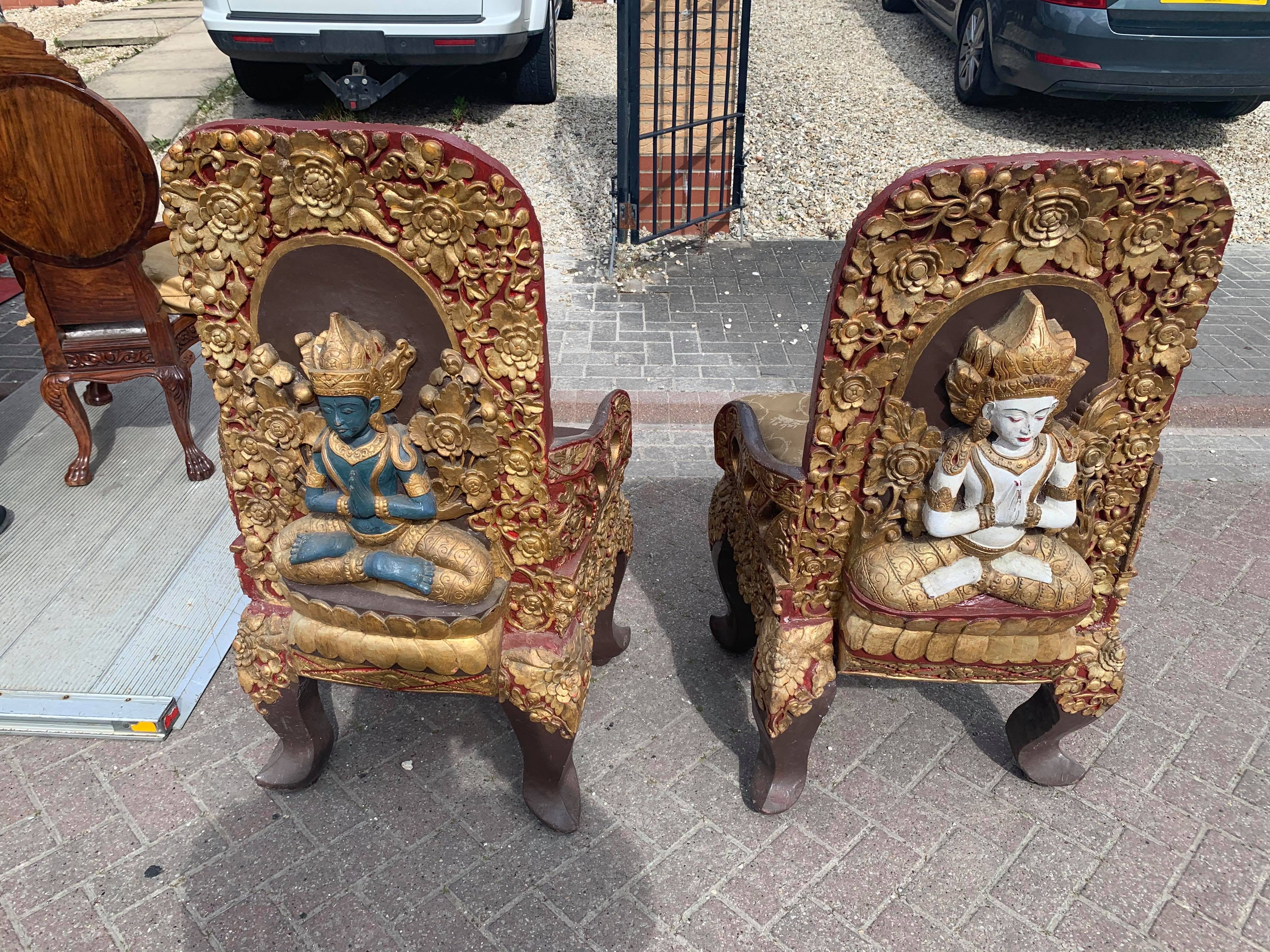 A pair of early 20thC Tibetan ceremonial chairs with gilt decoration to top.