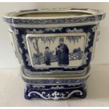 A Chinese 20thC blue and white planter + stand. 26 x 22 x 23cms.