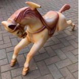 A 1950's fairground fibreglass horse from a child's ride. 67 h x 128 w x 28cms d.