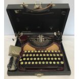 An early 20thC Corona typewriter with travel case.