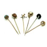 Six 19thC stick pins to include horseshoe with seed pearls, jet, shell cameo, reverse painted fox