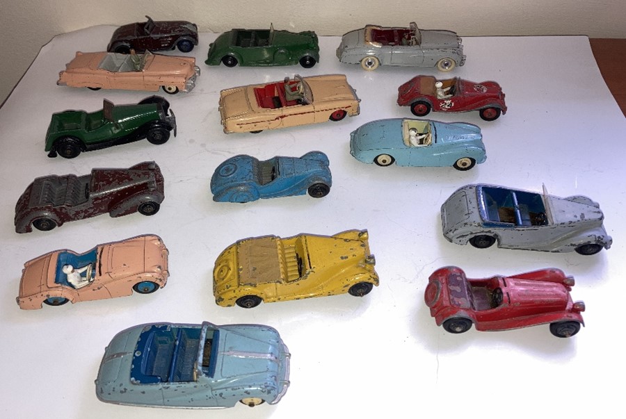 A large collection of playworn Dinky convertible cars to include Jaguar, Armstrong Siddelet, Sunbeam