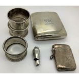 Silver to include cigarette case, vesta case, whistle London 1881 and 3 napkin rings. 199.2gms.
