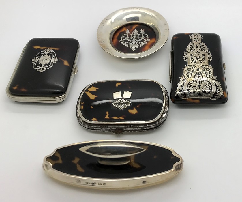 Five pieces tortoiseshell including silver piqué pin tray, three purses and nail buffer, 1 purse