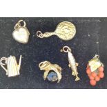 Six various yellow metal charms to include fish, mirror, coffee pot marked 9ct gold, coral and