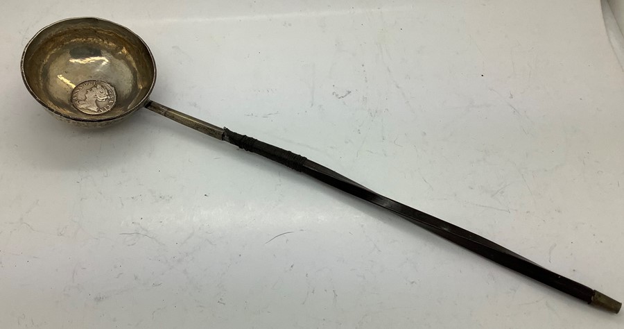 A silver and baleen toddy ladle a/f with a Queen Anne 1707 shilling to centre. 41.5gms.