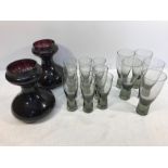 Homegaard drinking glasses 5 x 13.5cms and 9 x 11.5cms and a pair of purple glass bulb vases.