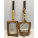 Two vintage tennis rackets, both in a press.