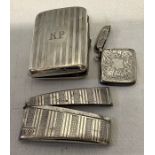 A silver card case with engine turned decoration, a cigarette card case and a vesta case with