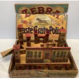 An early 20thC Zebra Paste Grate Polish advertising/display box containing vintage toy fort and a