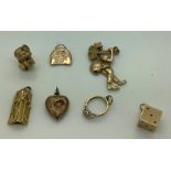 Seven various 9ct gold charms including chimney sweep, dice ring, heart, bell and bird. 16.2gms