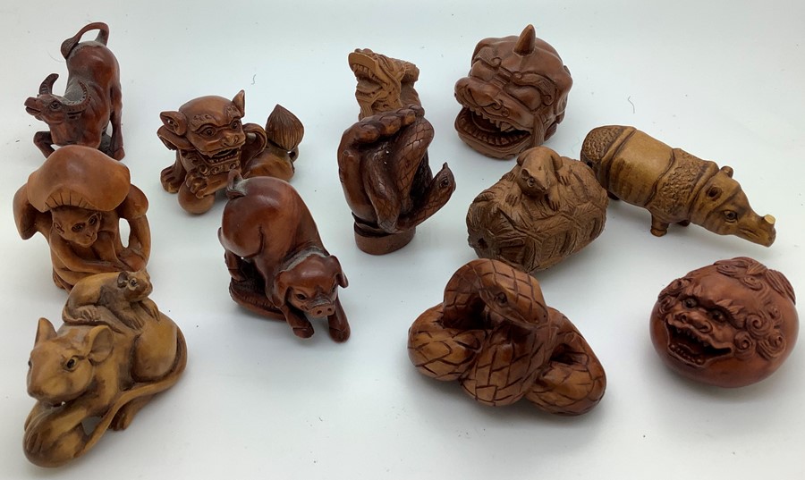 Twenty eight various modern Chinese wood and tagua nut and resin netsukes. Condition ReportTwo